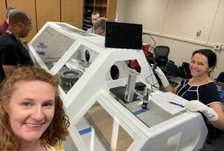 The OSIRIS-REx team practices for sample return at NASA's Johnson Space Center. From front left going clockwise are Michelle Thompson, Christopher Snead, Kevin Righter, Wayland Connelly, Lindsay Keller, and Nicole Lunning.