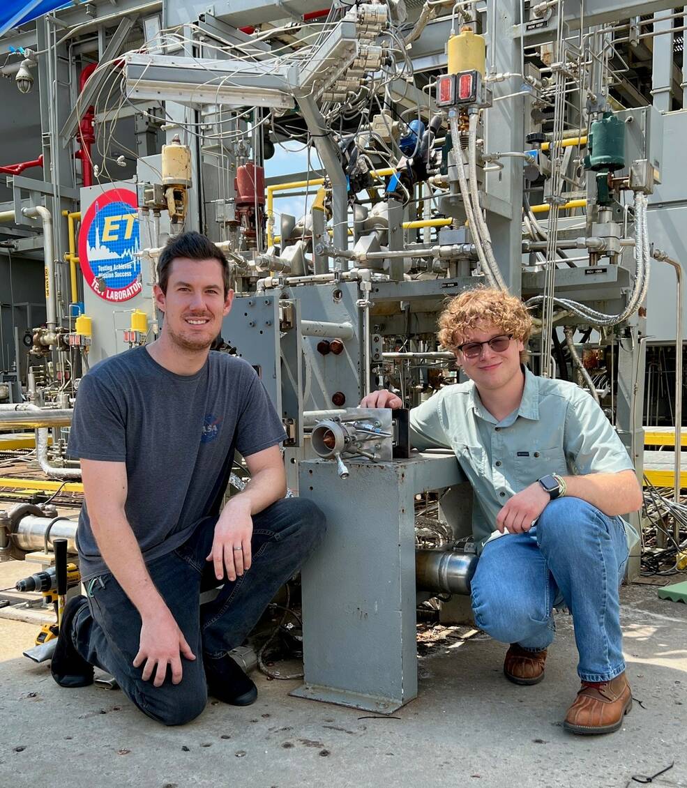 Thomas Teasley, left, a liquid propulsion engineer at NASAs Marshall Space Flight Center, and Dalton Luedke, an intern from Georgia Tech, display Luedkes subscale engine, MARLEN.