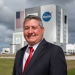 A portrait of Kennedy Space Center's David Sumner with the Vehicle Assembly Building in the background.