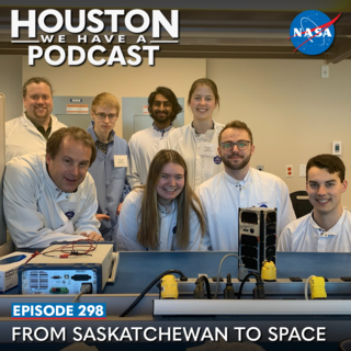 A group of students and project managers join for a photo with the RADSAT-SK satellite. 