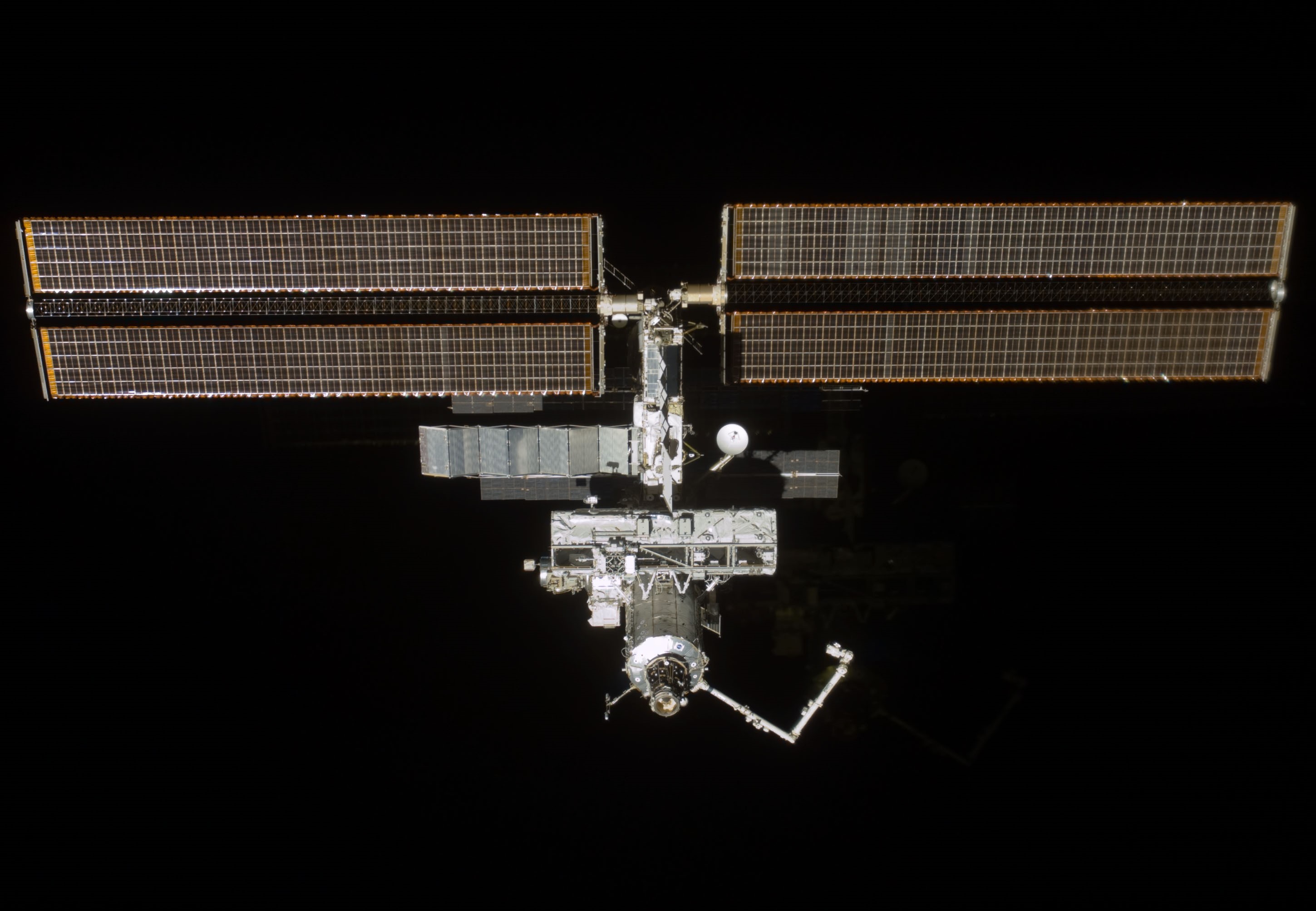 The space station as seen from the departing STS-110, showing the S0 truss mounted on Destiny
