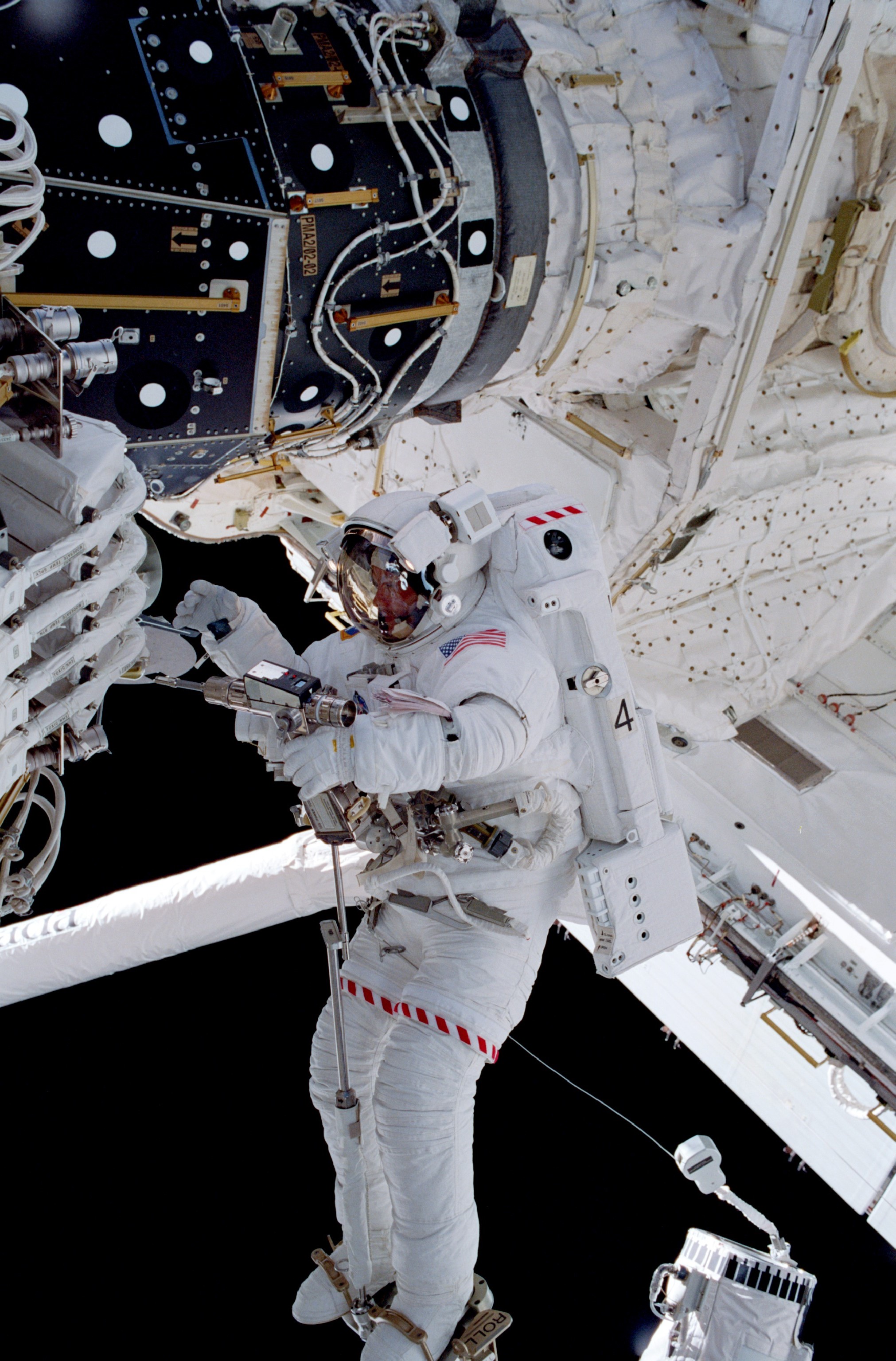 NASA astronaut Michael E. Lopez-Alegria working outside the space station during STS-92