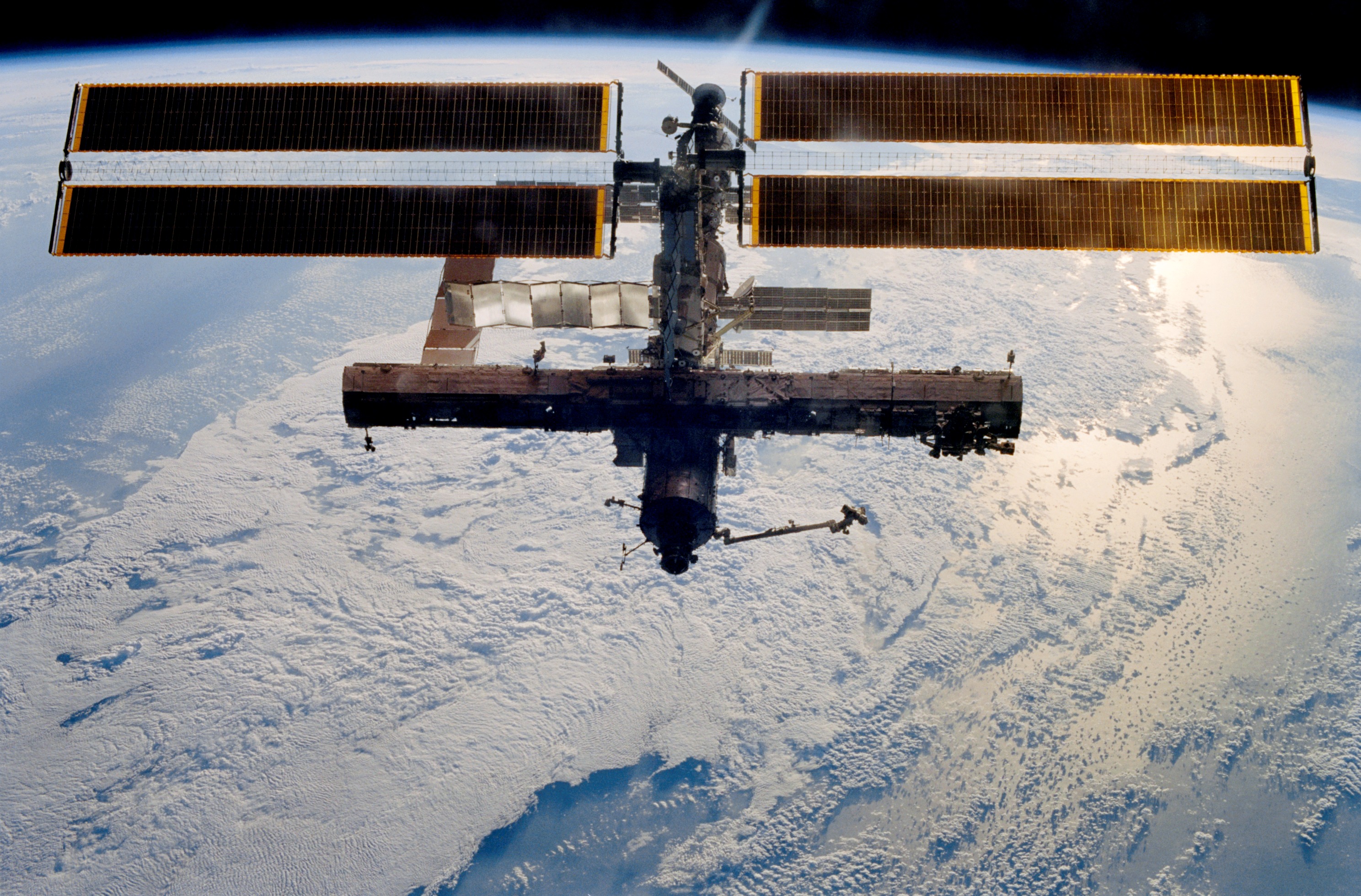 The space station as seen by the departing STS-113 crew, with the newly installed P1 truss visible at right