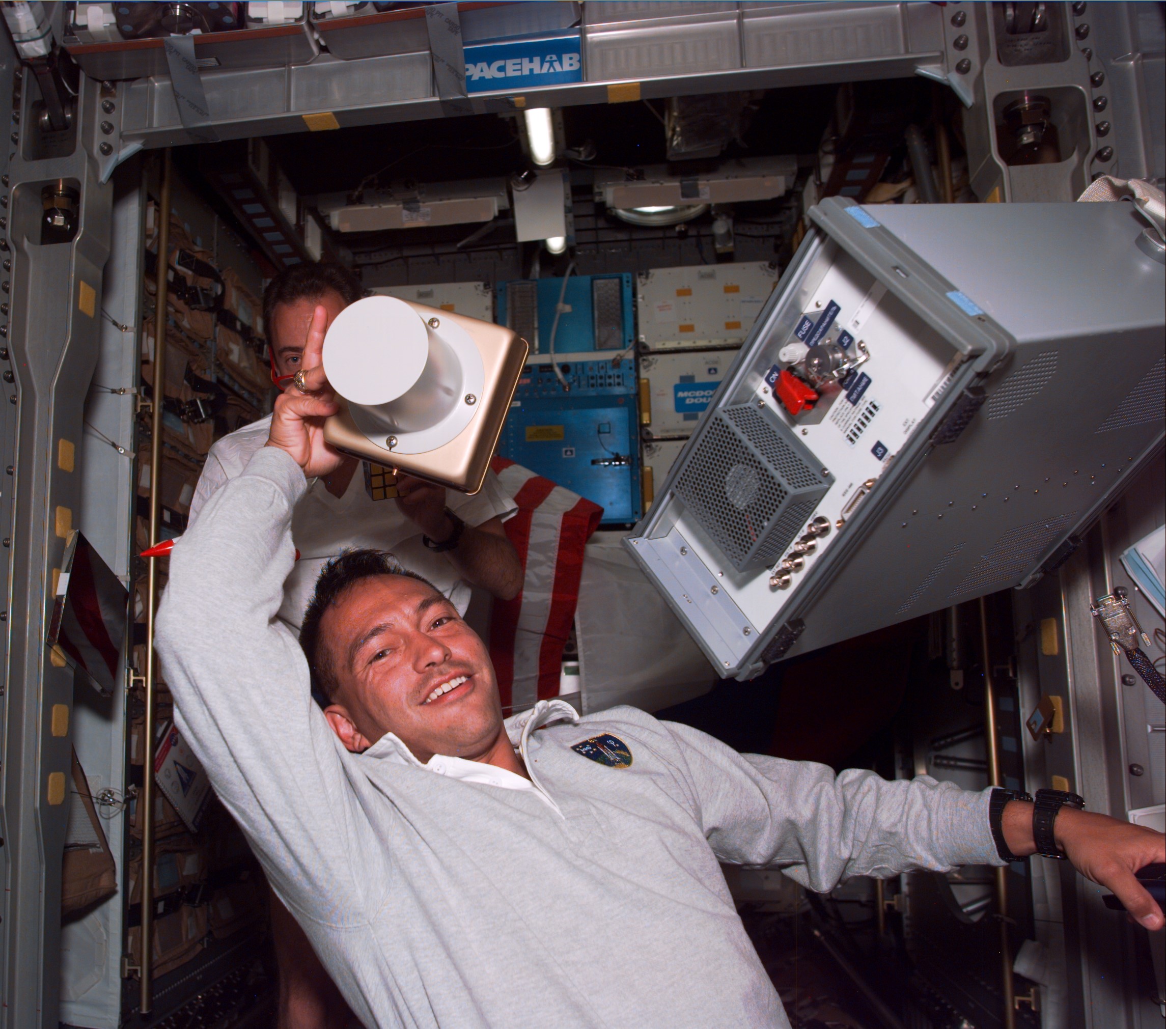 Carlos I. Noriega sets up an experiment during the STS-84 mission