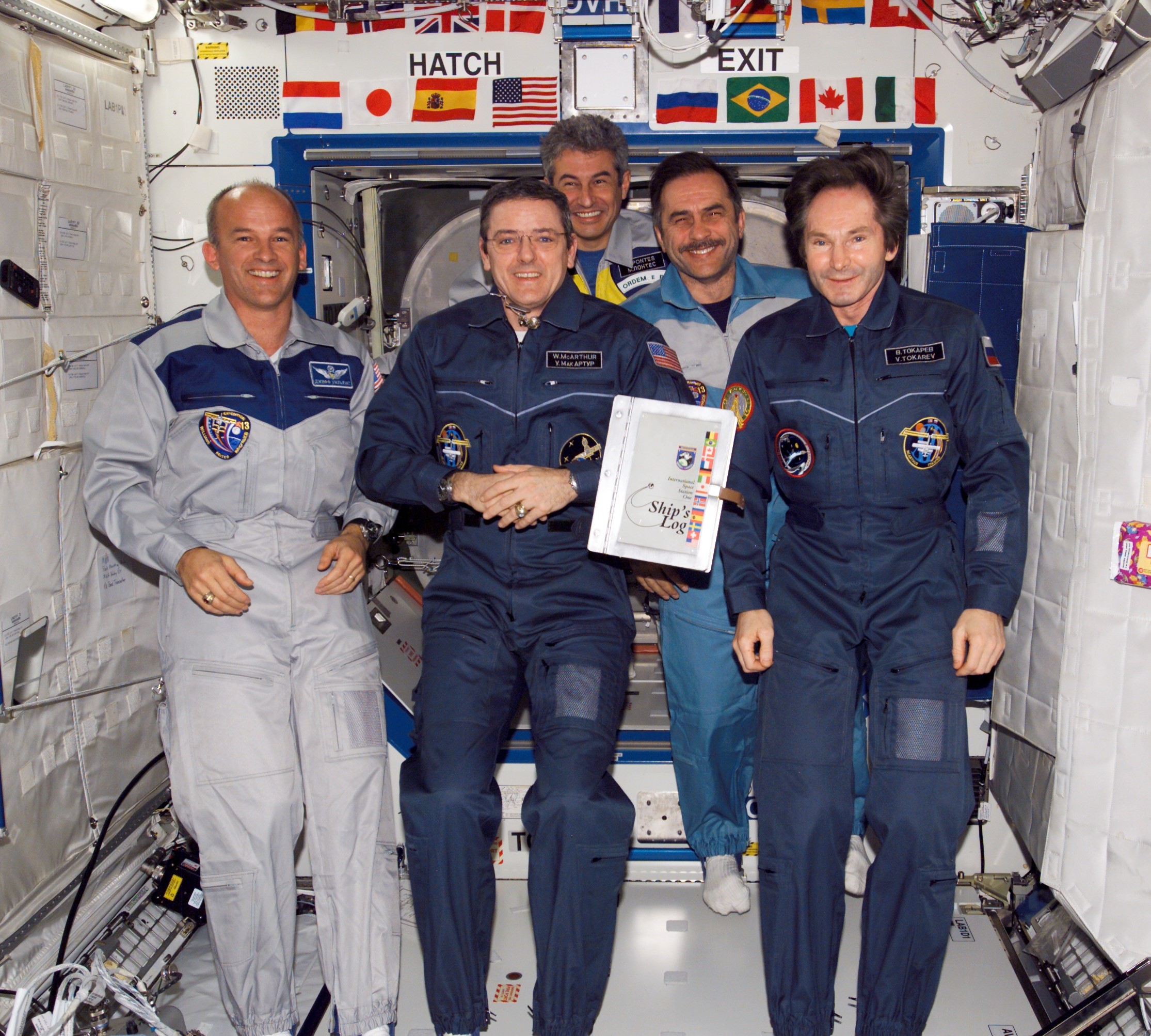 Brazilian astronaut Marcos Pontes, center at rear, with his Expedition 12 and 13 crewmates