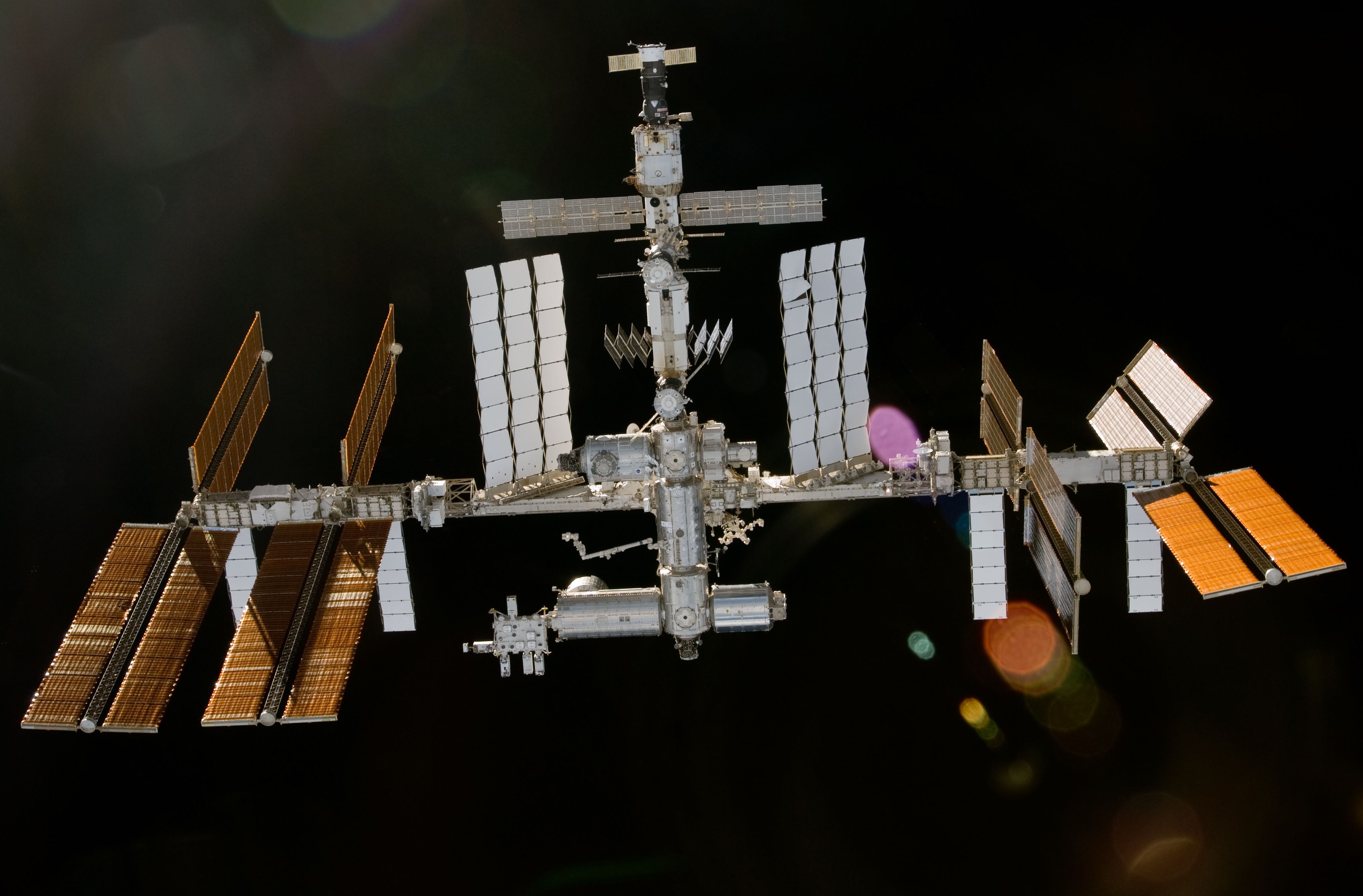The space station as seen from the departing STS-130, showing the Tranquility Node 3 and Cupola berthed at the Unity Node 1, left of center.