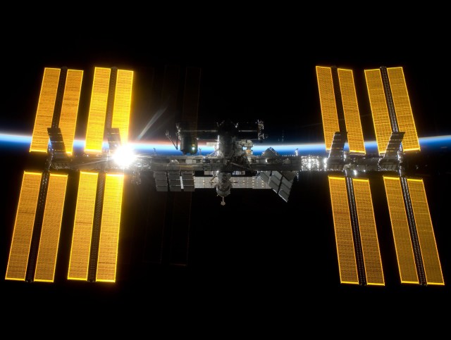 The space station as seen from the departing STS-119, with the newly added S6 truss segment and solar arrays