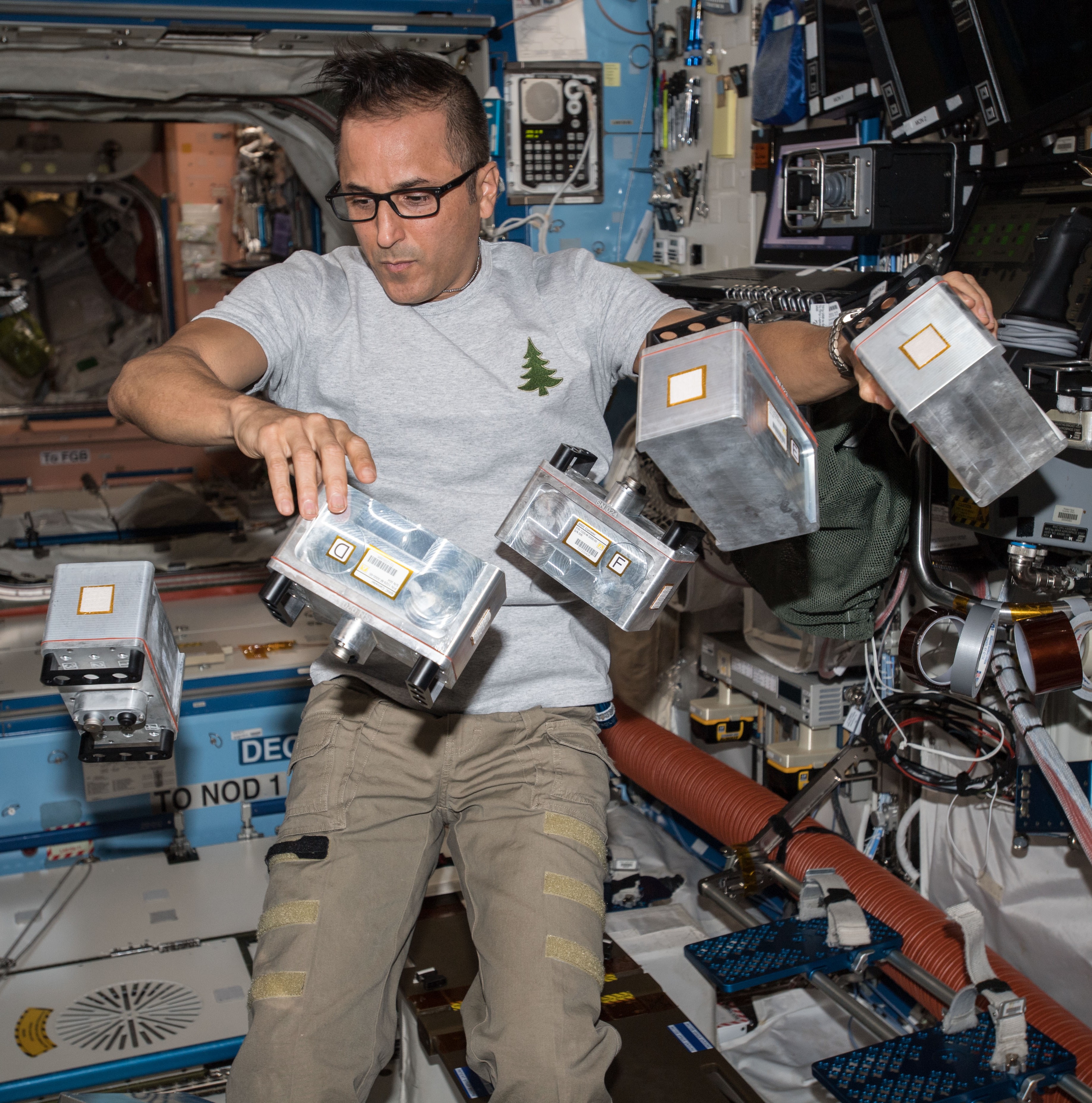 NASA astronaut Joseph M. Acaba working with the Biological Research in Canisters experiment.