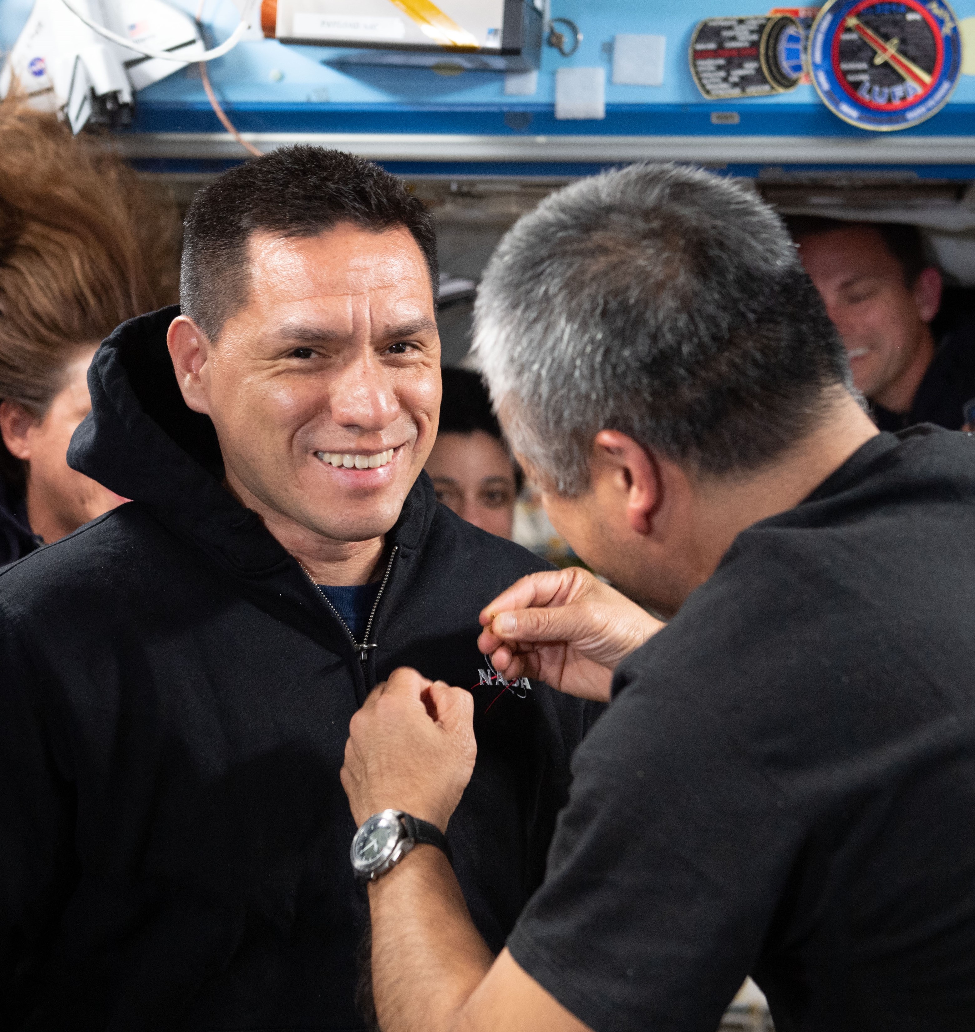 NASA astronaut Francisco “Frank” C. Rubio receives his gold astronaut pin from Japan Aerospace Exploration Agency astronaut and fellow Expedition 68 crew member Koichi Wakata