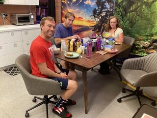 Nathan Jones, Ross Brockwell, and Kelly Haston are seen sitting at the table while eating a meal in the CHAPEA habitat. 