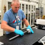 Chris Honea, a NASA Marshall Space Flight Center technician supporting payloads, unwraps a payload Aug. 18 for semiconductor research that recently arrived from the International Space Station. The experiment studied crystal growth in microgravity.