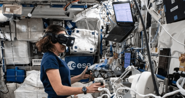 NASA astronaut Megan McArthur participate an experiment from the European Space Agency that uses virtual reality gear and tests a crew member’s aptitude when maneuvering a computer-generated robotic arm toward a target.