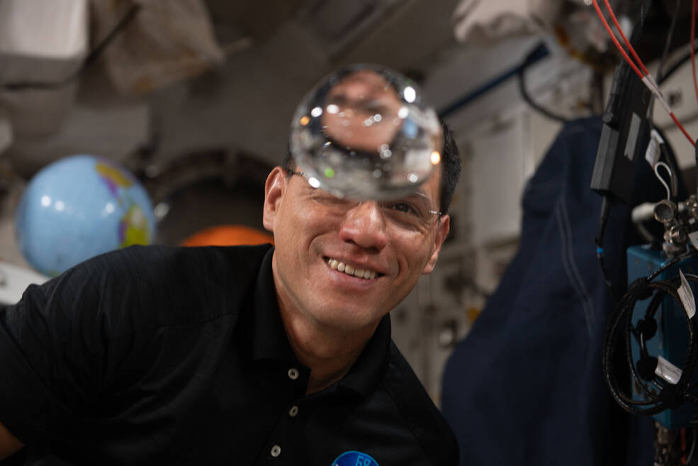 NASA astronaut Frank Rubio has fun with fluid physics as he observes the behavior of a free-flying water bubble inside the International Space Station's Kibo laboratory module.