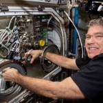 Astronaut Stephen Bowen works in the Microgravity Science Glovebox