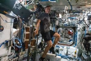 Astronaut Andreas Mogensen works out on the exercise cycle