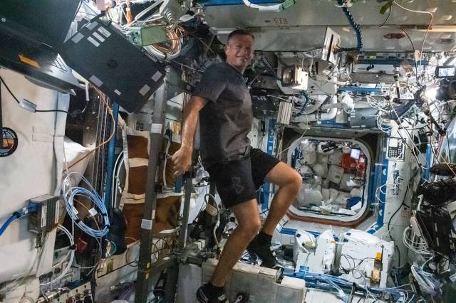Astronaut Andreas Mogensen works out on the exercise cycle