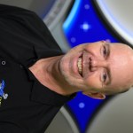 Portrait of Kennedy Space Center's Jim Hall with the Launch Services Program insignia in the background.