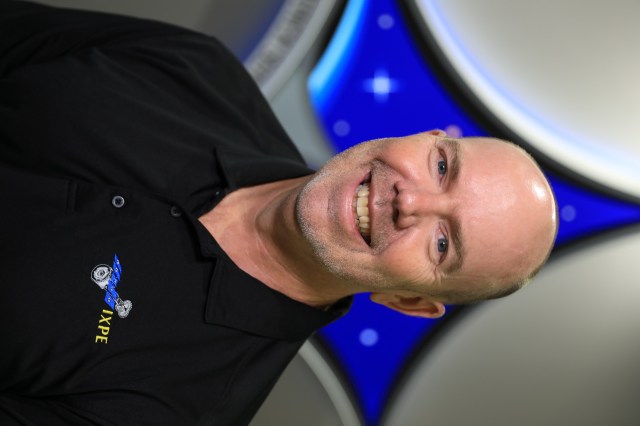 Portrait of Kennedy Space Center's Jim Hall with the Launch Services Program insignia in the background.