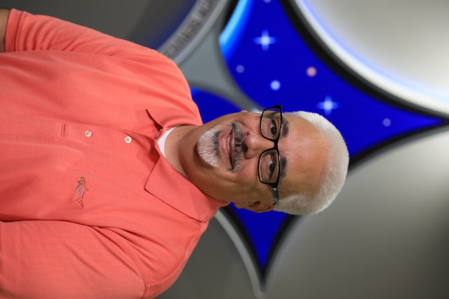 A portrait of Kennedy Space Center's Jorge Piquero with the Launch Services Program insignia in the background.