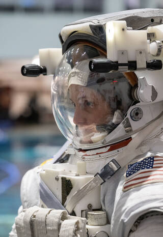 Loral O'Hara suits up for spacewalk training in NASA's Neutral Buoyancy Laboratory.