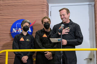 Medical Officer, Nathan Jones, stands in front of his three crewmates as he shares a statement before ingressing to the CHAPEA habitat.