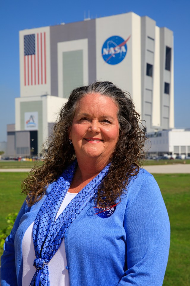 A portrait of Kennedy Space Center's Robyn Mitchell with the Vehicle Assembly Building in the background.