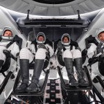 The SpaceX Crew-7 crew members are seated inside the Dragon spacecraft wearing their SpaceX spacesuits.
