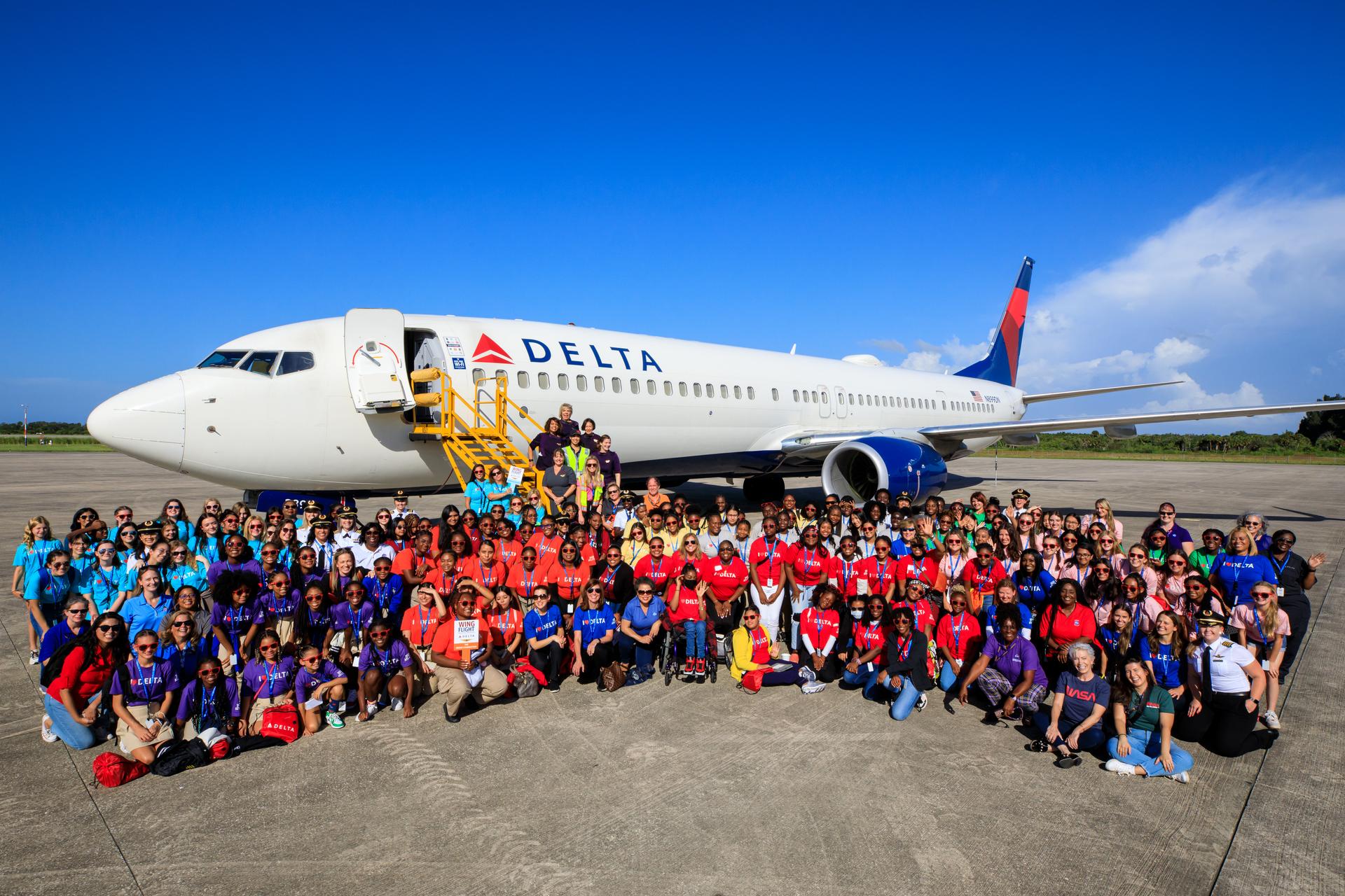 Students from various schools and organizations with a STEM (science, technology, engineering, math) focus are photographed with employees from NASA’s Kennedy Space Center at the Launch and Landing Facility following their arrival to Kennedy on Friday, Sept. 22, 2023, as part of Delta Air Lines’ Women Inspiring Our Next Generation (WING) flight.
