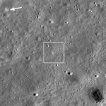 A photo of the surface of Earth's Moon. The surface looks like the top of a cake, with small craters like bubbles in the batter across the image. A white square in the center surrounds the Chandrayaan-3 Moon lander, a tiny dark dot surrounded by white.