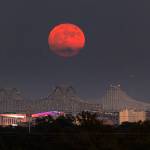 A Super Blue Moon rises above the Mississippi River and the Crescent City Connection Bridge in New Orleans, Aug. 30.