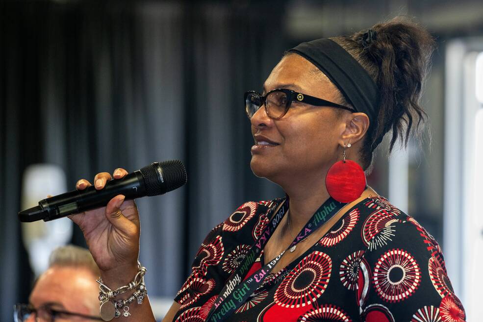 Katherine Stevenson-Chavis, astrophysics branch chief in the Science and Technology Office, asks a question related to employee travel receipts during the supervisors all-hands meeting.