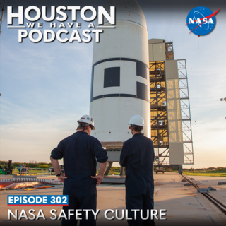 Two people are pictured in front of the Ascent Abort-2 test vehicle secured on the pad at Launch Complex 46 at Cape Canaveral Air Force Station in Florida after rollback of the vertical integration facility on July 1, 2019. 