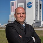 A portrait of Kennedy Space Center's Paul Sierpinski with the Vehicle Assembly Building in the background.