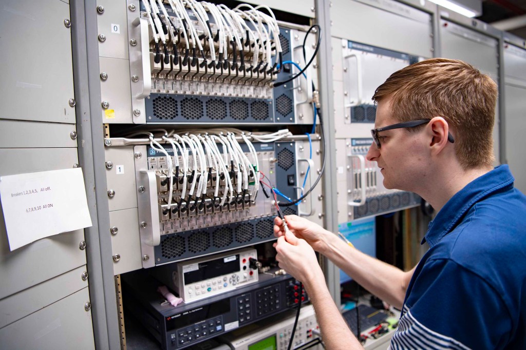 NASA instrumentation engineer Tristan Mooney testing new wiring for the he High Speed Data Acquisition System