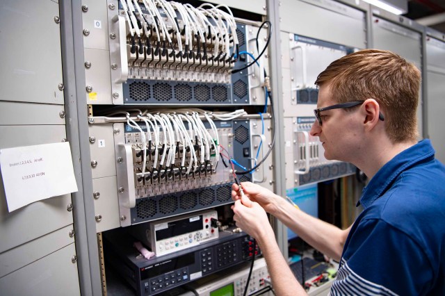 NASA instrumentation engineer Tristan Mooney testing new wiring for the he High Speed Data Acquisition System