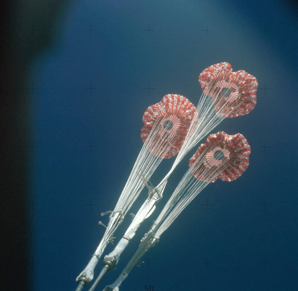 At 10,000 feet, the three main parachutes opened to further slow the CM’s descent