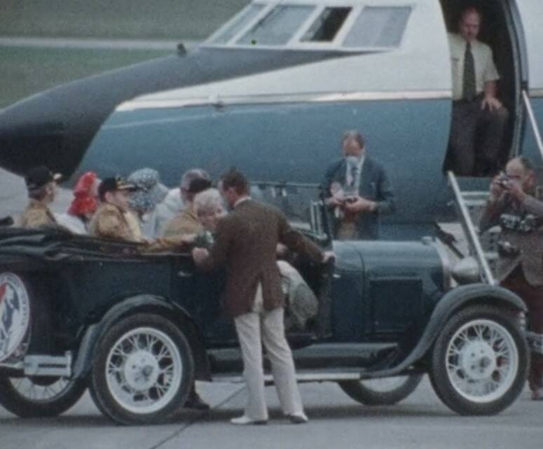 Skylab 3 astronauts and their wives climb aboard a vintage 1929 Ford to depart Ellington