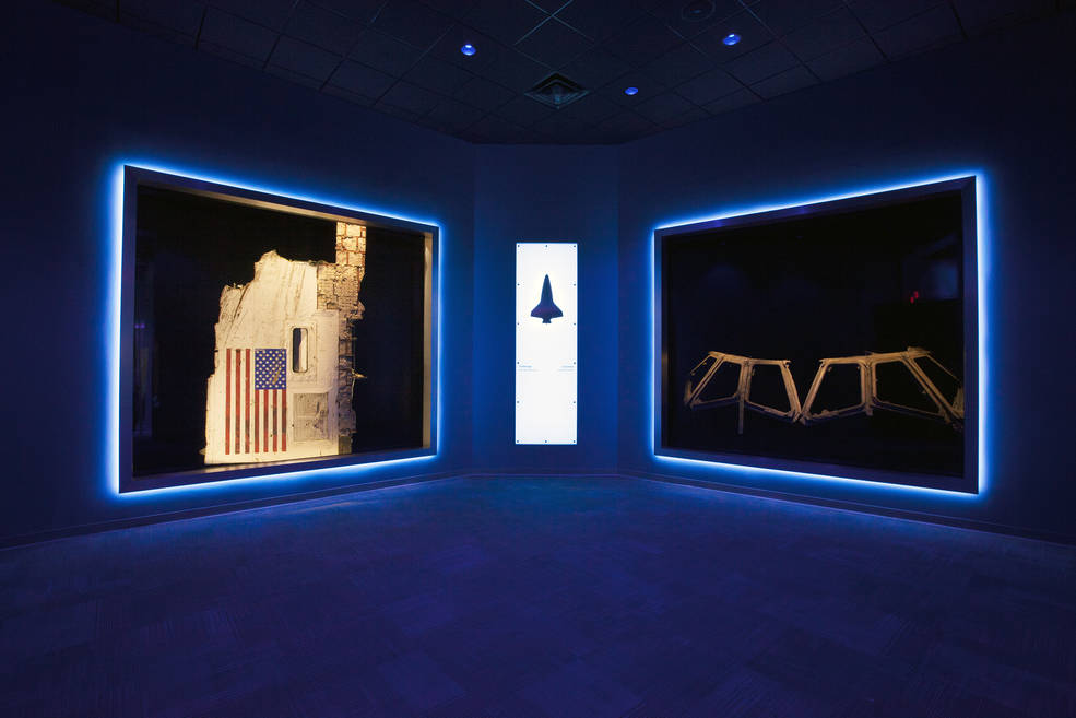 A section of the fuselage recovered from space shuttle Challenger, left, and the flight deck windows recovered from space shuttle Columbia are part of a new, permanent memorial at the Kennedy Space Center Visitor Complex.