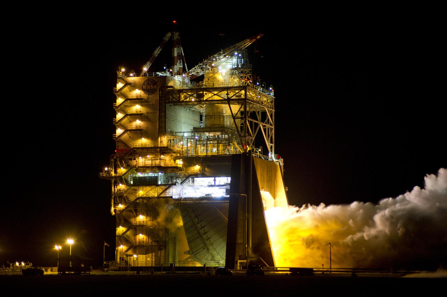 a vapor cloud appears to glow during night engine test on the A-1 Test Stand