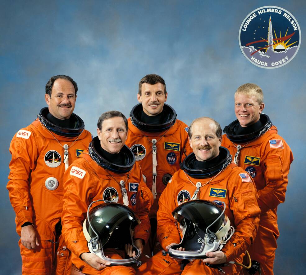 The STS-26 crew of John M. “Mike” Lounge, left, Richard “Dick” O. Covey, David C. Hilmers, Frederick H. “Rick” Hauck, and George D. “Pinky” Nelson wearing the new Launch and Entry Suits