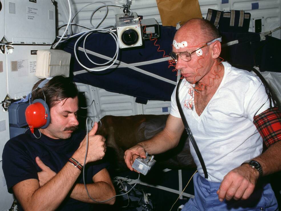 Thornton conducts an audiometry or hearing evaluation on fellow crew member Dale A. Gardner