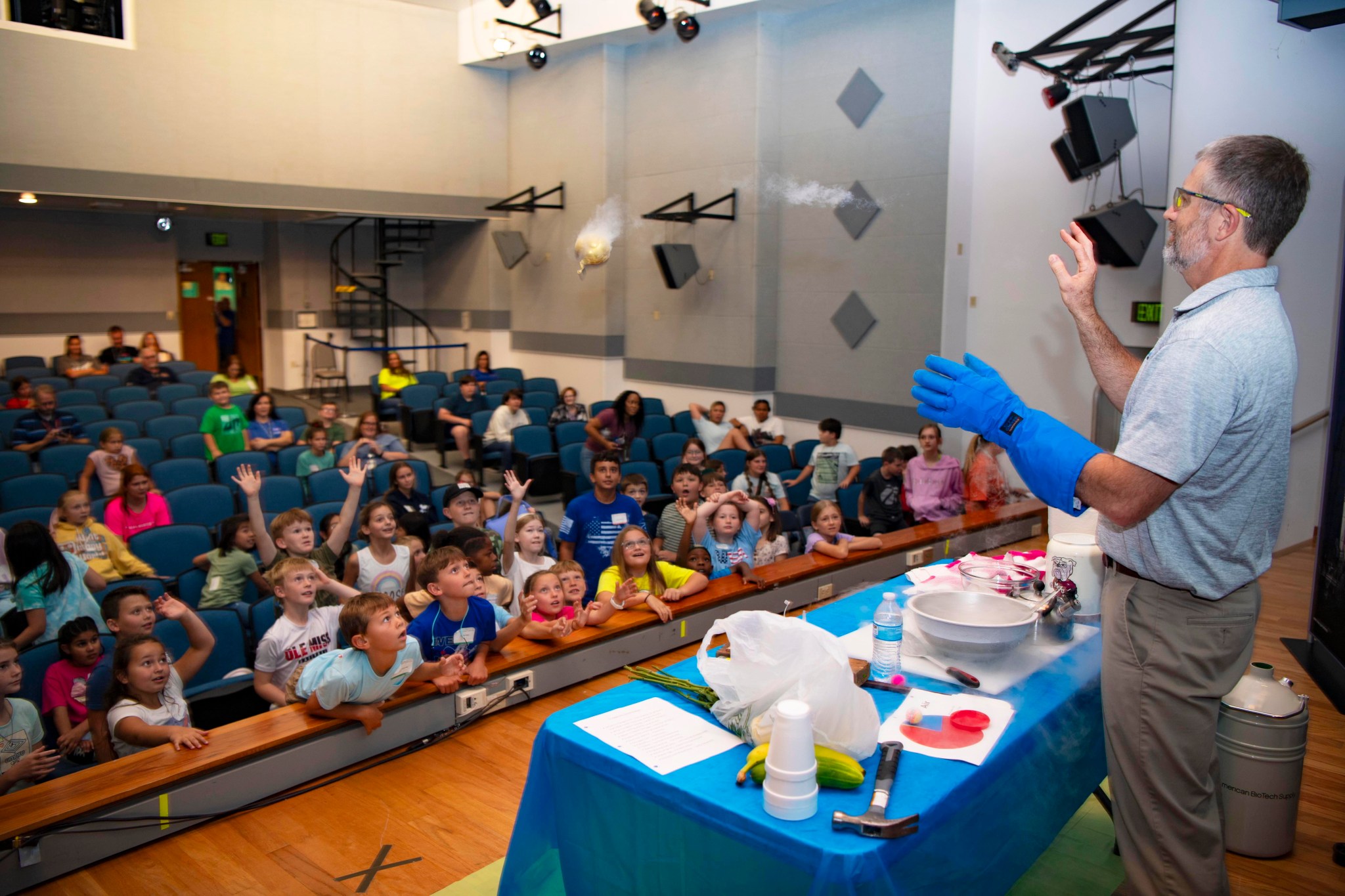Allen Forsman demonstrates a cryogenics experiment as Take Our Children to Work Day participants watch on in amazement.