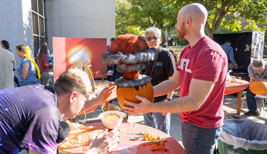 JPL Pumpkin Carving Contest 2023 - Several people working on their displays
