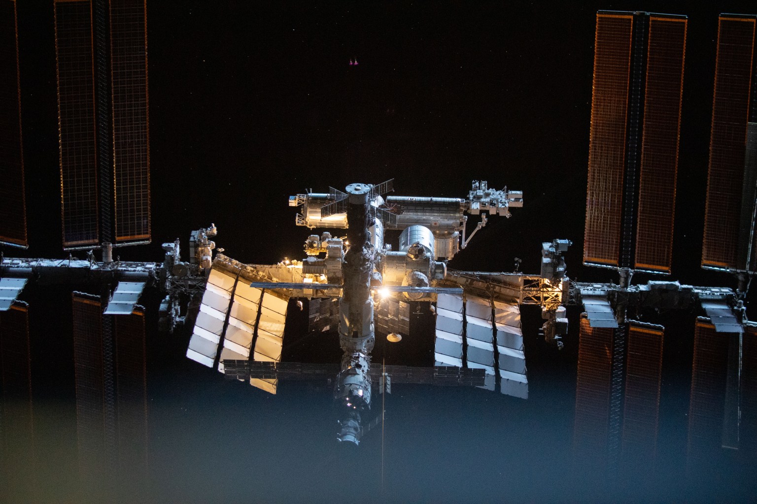 iss066e080166 (Nov. 8, 2021) --- The International Space Station is pictured from the SpaceX Crew Dragon Endeavour during a fly around of the orbiting lab that took place following its undocking from the Harmony module’s space-facing port on Nov. 8, 2021.