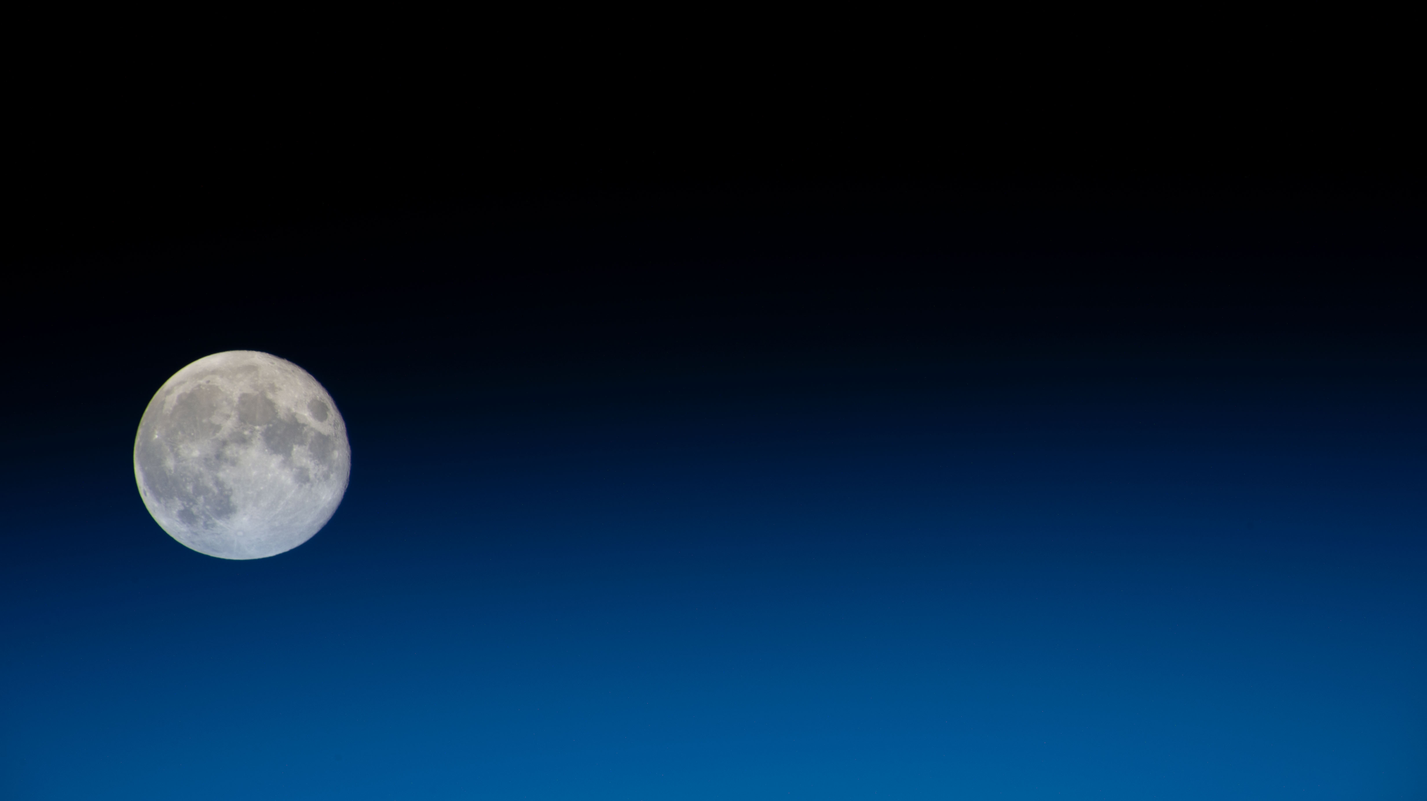 A Full Moon with Earth's Blue Glow Beneath it - NASA