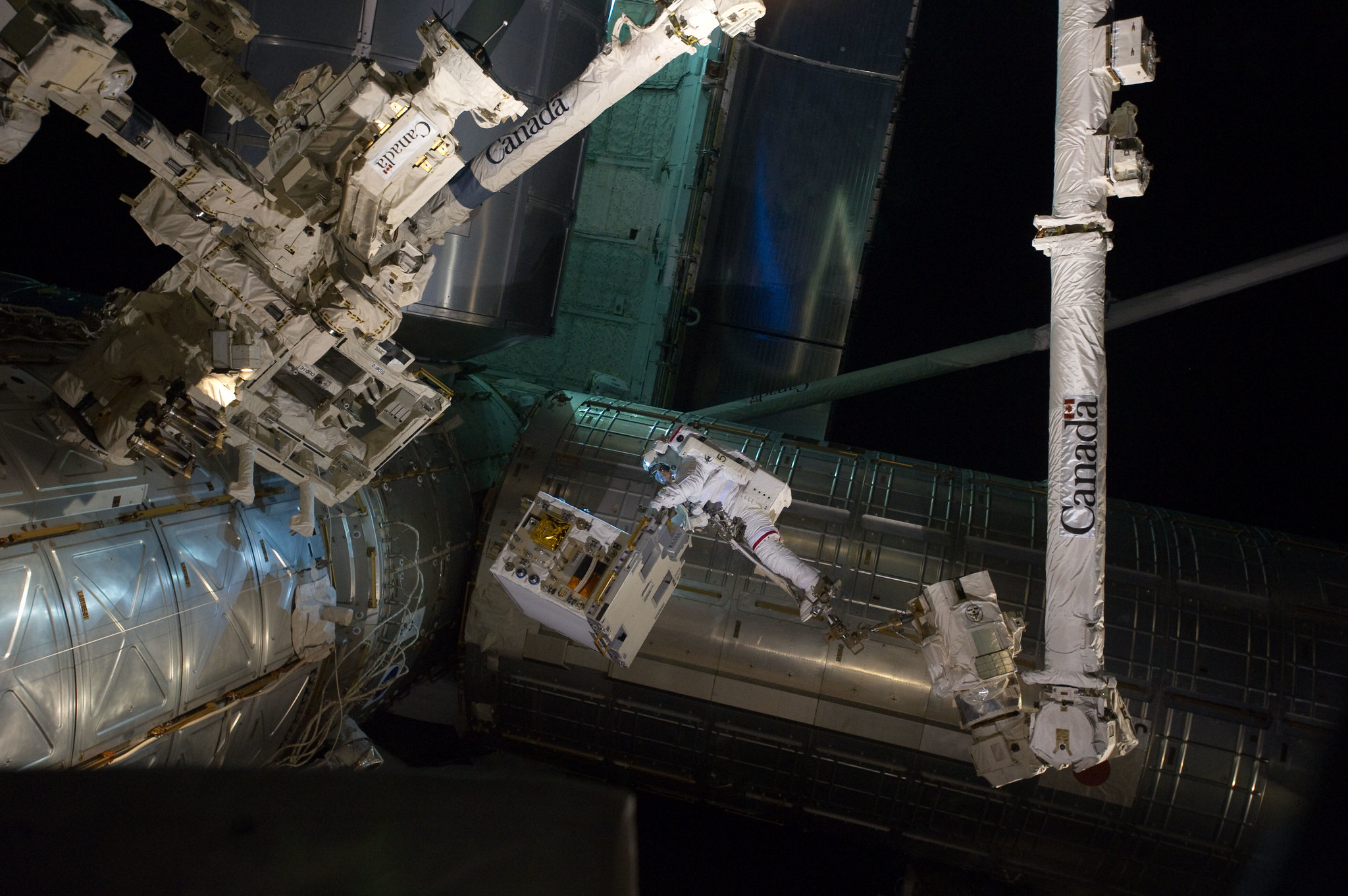 Spacewalking astronauts successfully transferred the RRM module from the Atlantis shuttle cargo bay to an temporary platform on the ISS's Dextre robot.