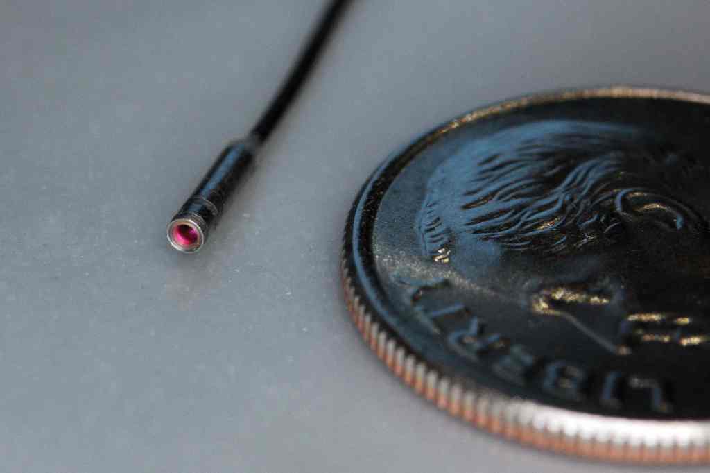 A mere 1.2mm in diameter - the thickness of a dime - VIPIR's borescope camera is the smallest commercial camera ever screened by NASA for use in space. Here, the device is shown next to a United States dime. Credit: NASA/Jon Kraeuter