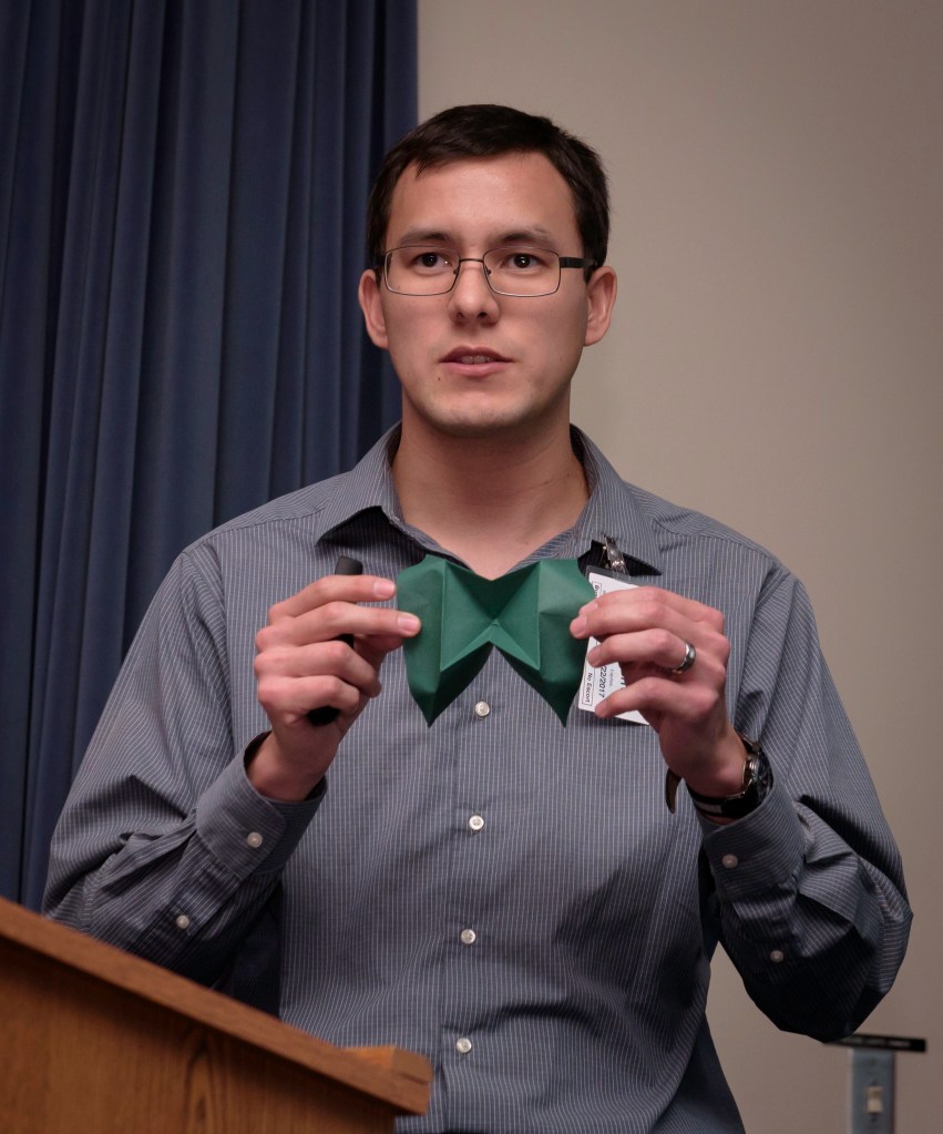 Alden Yellowhorse holding origami