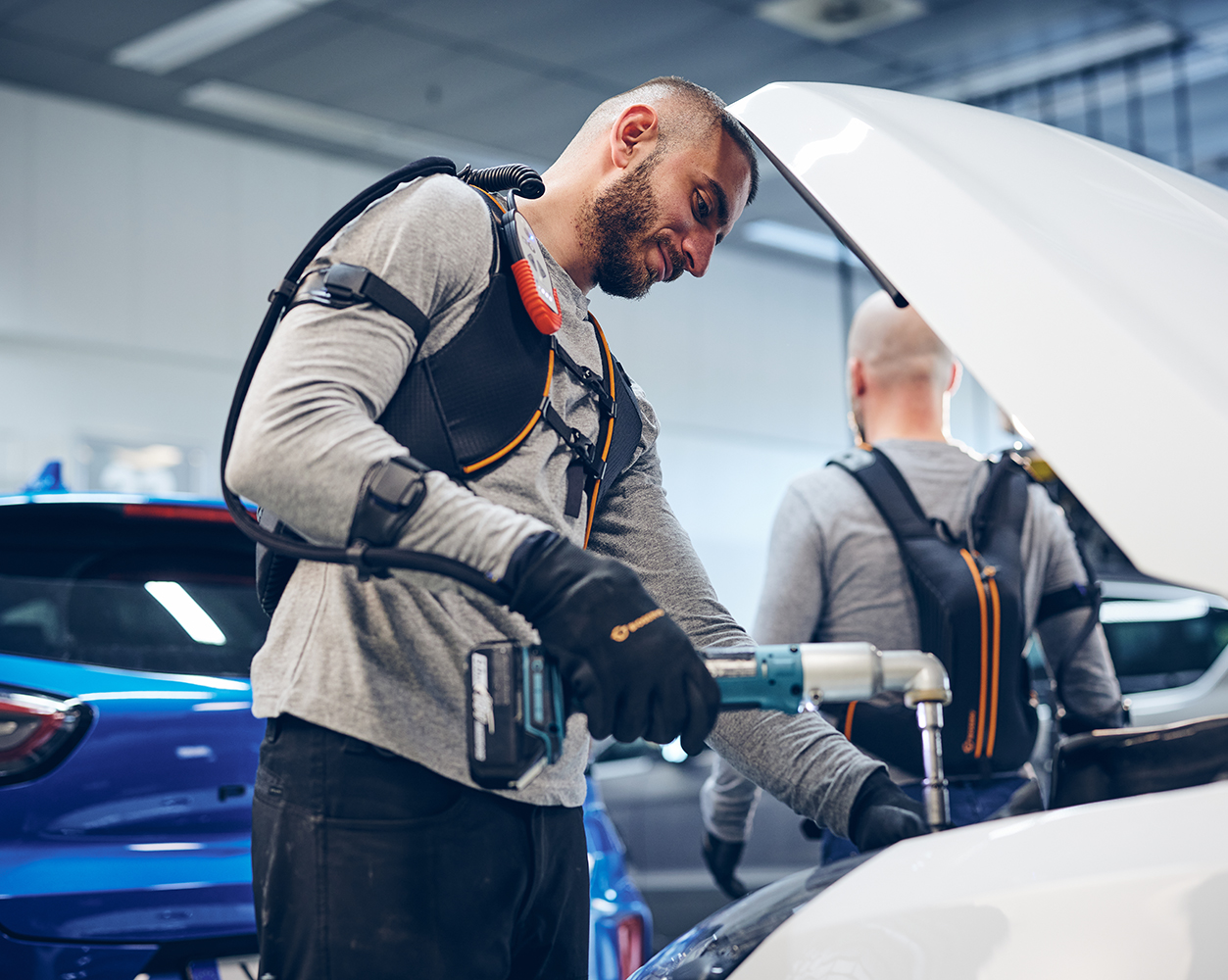 People working on vehicles.