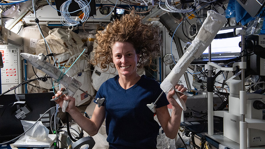 Astronaut Loral O'Hara shows off spacewalking tools aboard the International Space Station.